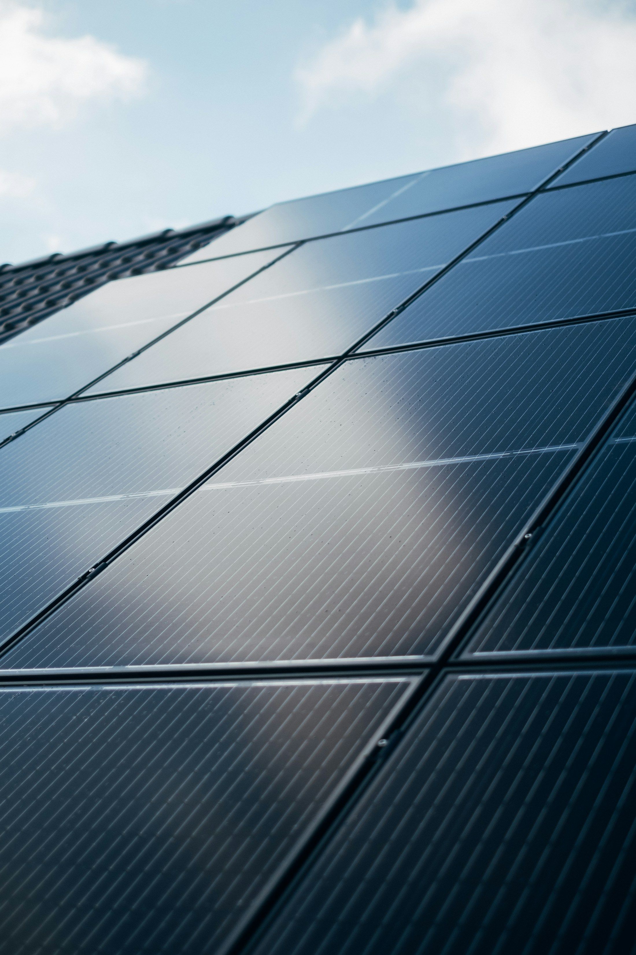 Close view of dark solar panel cells catching the light